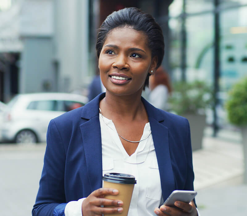 Woman appearing confident with coffee and cell phone