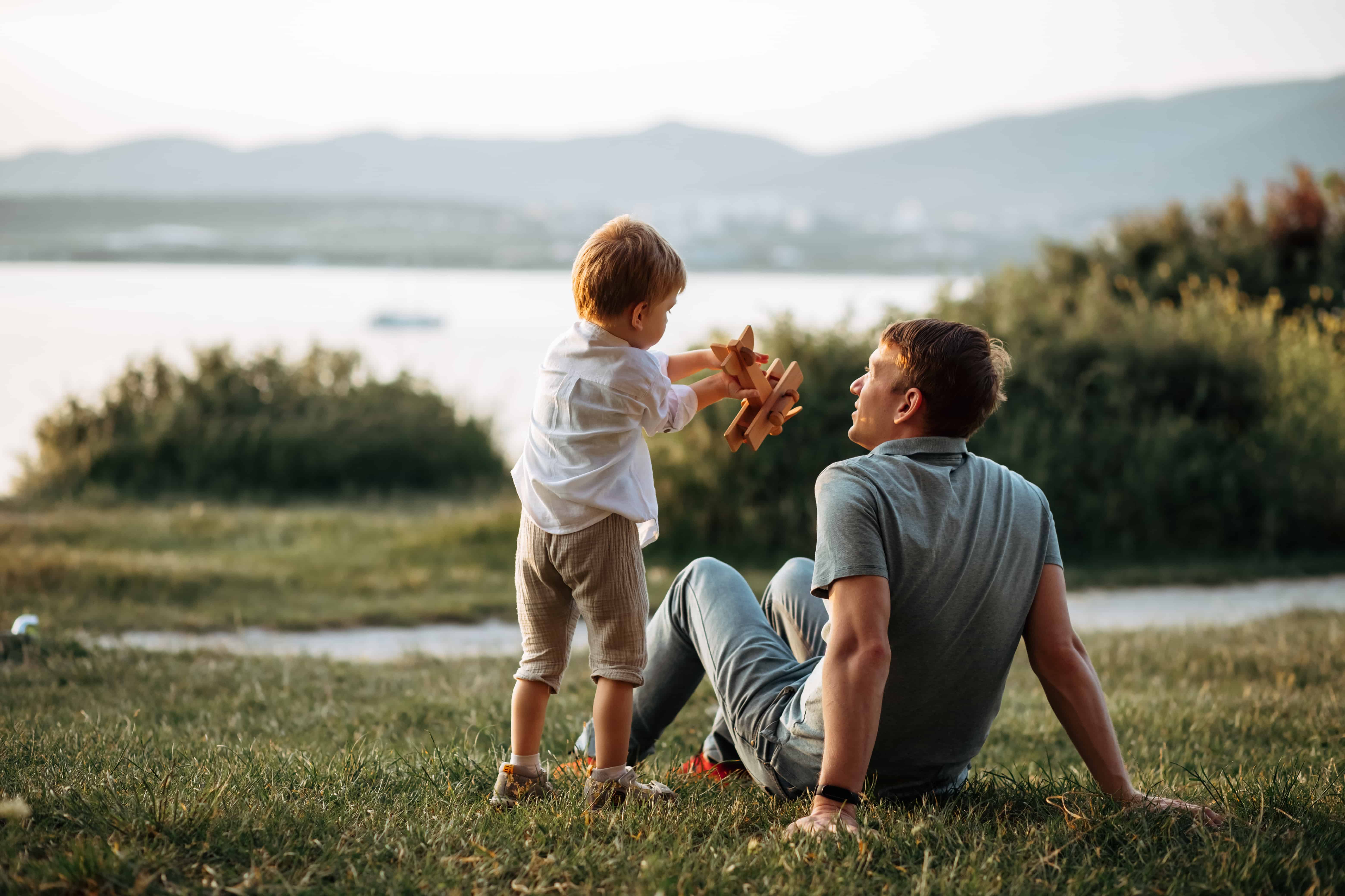 dad and son play on the seashore, vacation with children